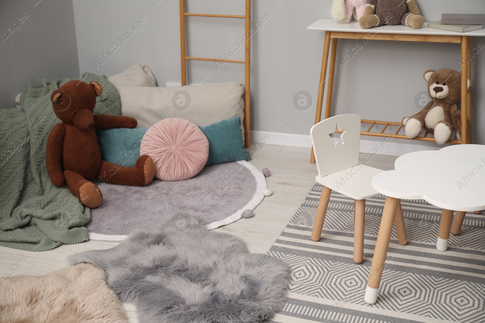 Photo of Stylish child room interior with modern furniture and toys