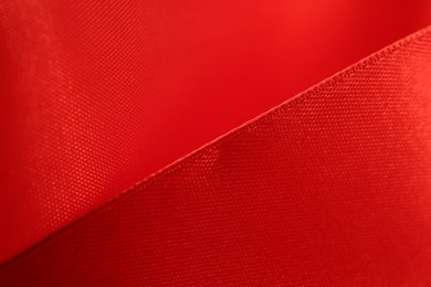 Beautiful red ribbon as background, closeup view