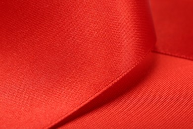 Beautiful red ribbon as background, closeup view