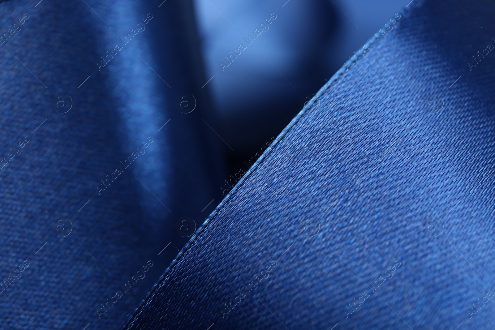 Photo of Beautiful blue ribbon as background, closeup view