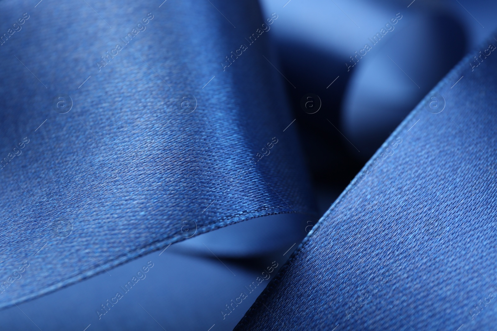 Photo of Beautiful blue ribbon as background, closeup view