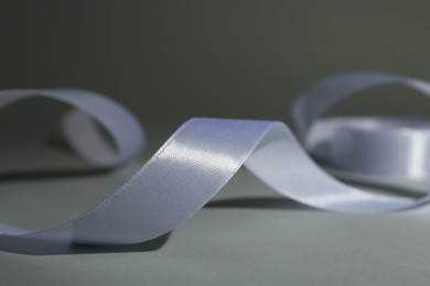 Beautiful white ribbon reel on gray background, closeup