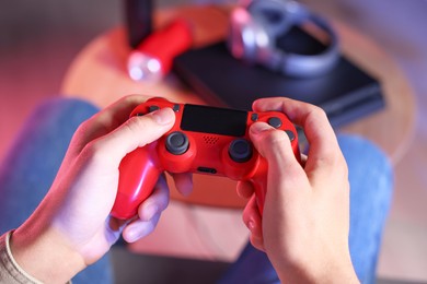 Photo of Man playing video games with controller at home, closeup