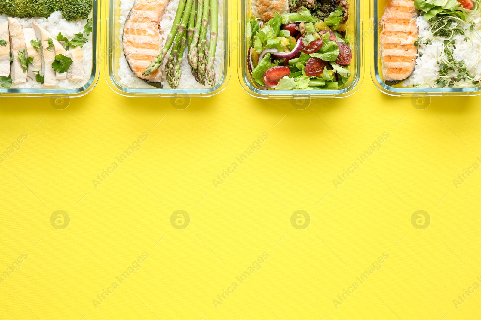 Photo of Healthy food. Different meals in glass containers on yellow background, flat lay. Space for text