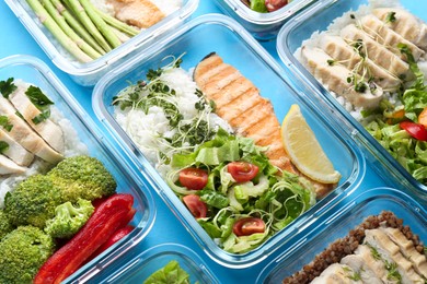 Healthy food. Different meals in glass containers on light blue background, above view