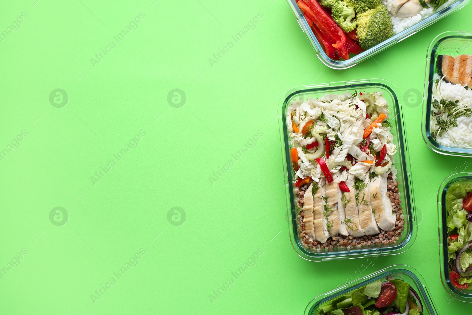 Photo of Healthy food. Different meals in glass containers on green background, flat lay. Space for text