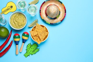 Flat lay composition with Mexican sombrero hat on light blue background, space for text