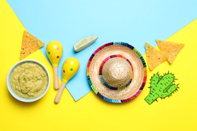 Photo of Mexican sombrero hat, nachos chips, guacamole, maracas and paper cactus on color background, flat lay