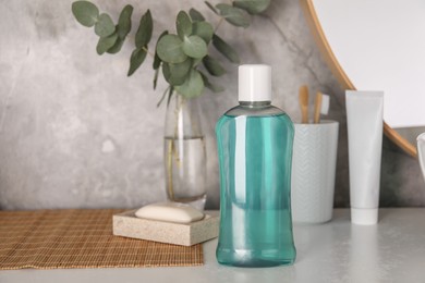 Bottle of mouthwash on light table in bathroom