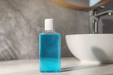 Bottle of mouthwash on light countertop in bathroom