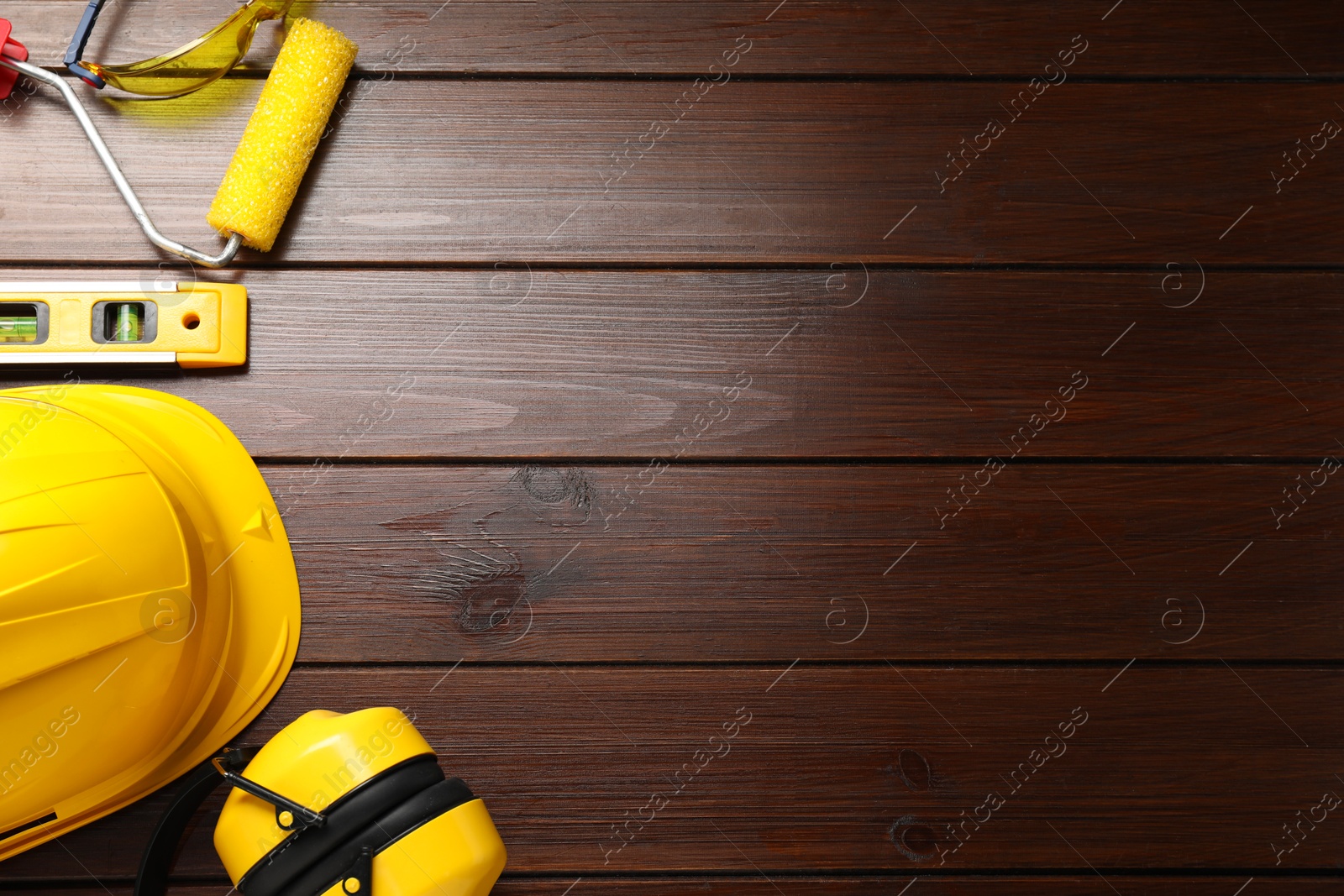 Photo of Flat lay composition with building level and other construction tools on wooden table, space for text