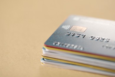 Photo of Stack of credit cards on table, closeup. Space for text