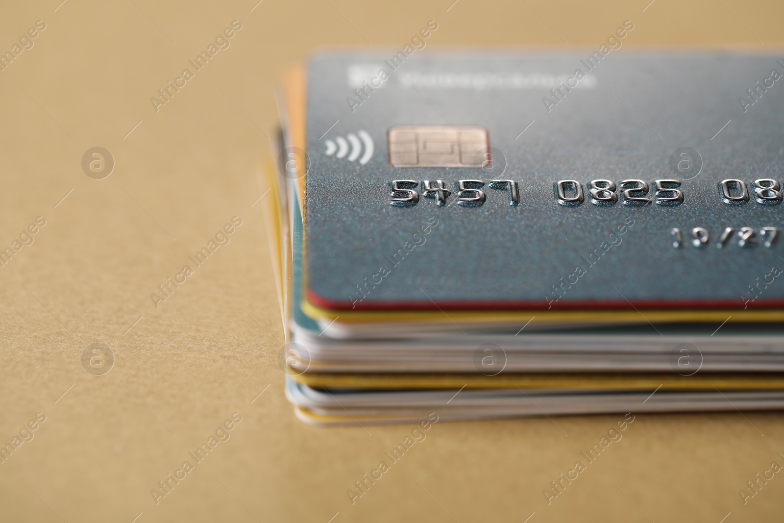 Photo of Stack of credit cards on table, closeup. Space for text