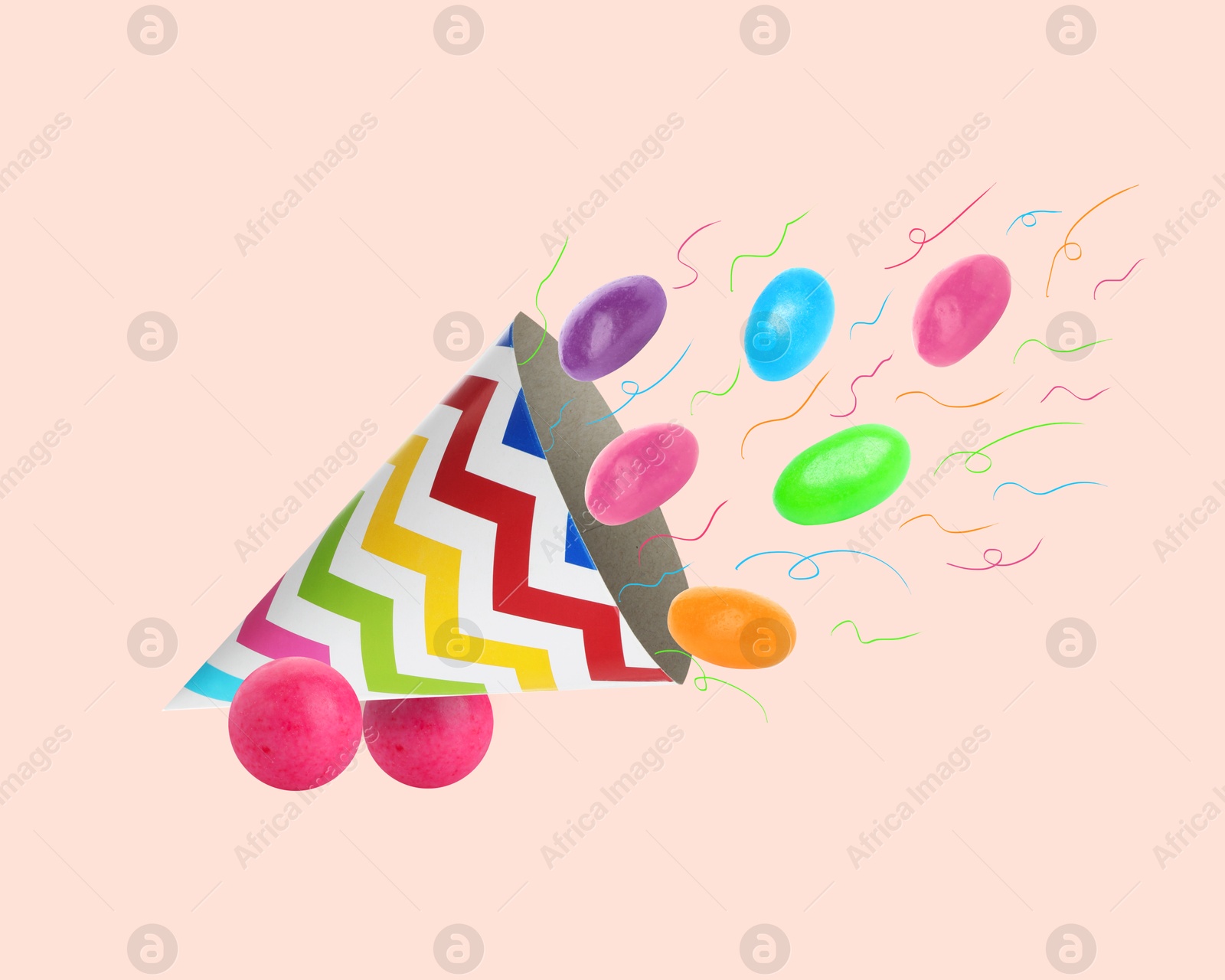 Image of Sweet candies flying out of cannon as party hat on beige background. Creative art collage