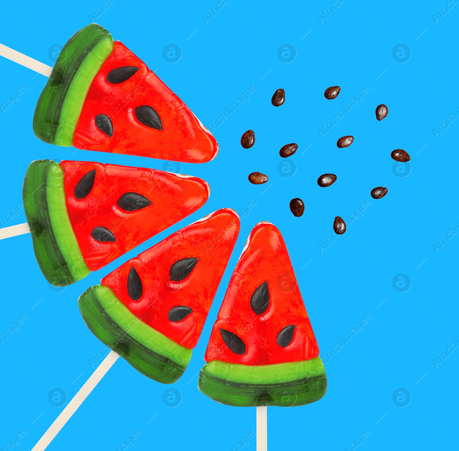 Image of Sweet watermelon shaped lollipops and seeds on blue background. Creative art collage