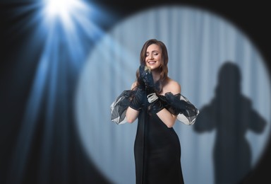 Image of Beautiful singer performing in spotlight on stage