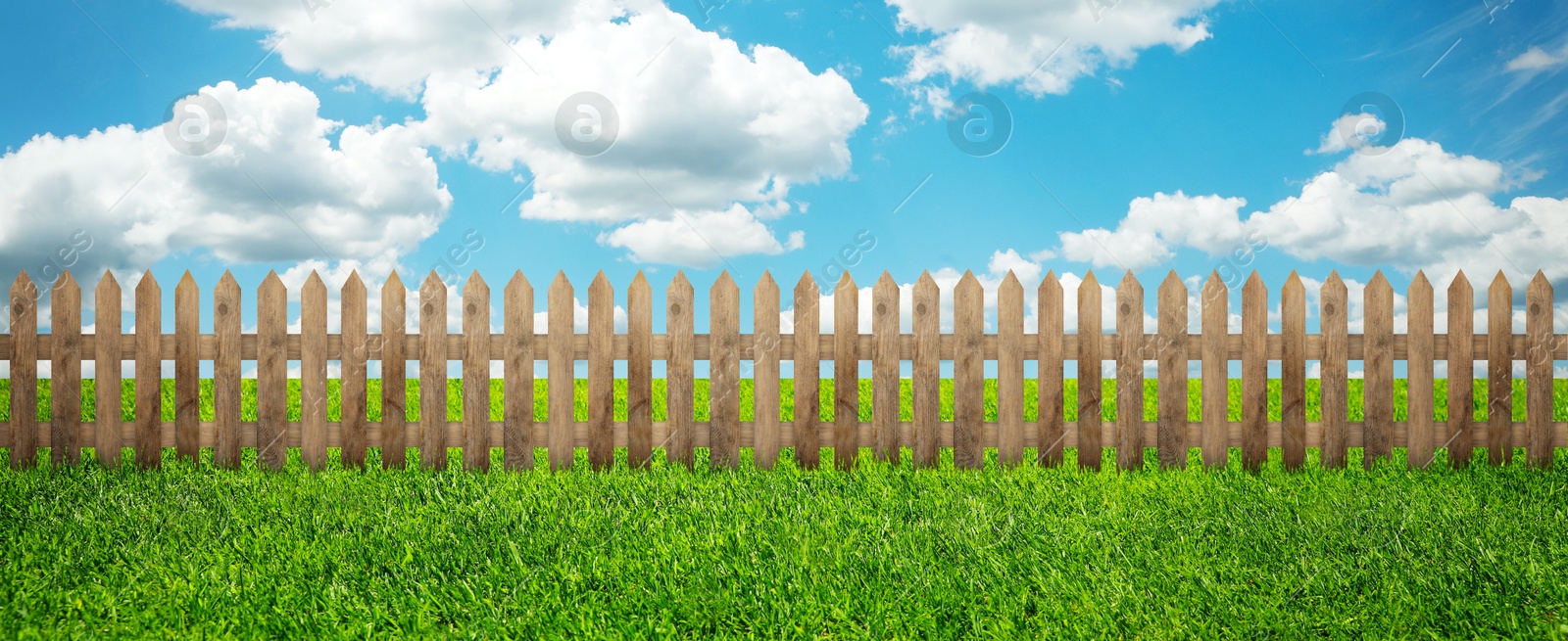 Image of Wooden fence and green grass outdoors, banner design