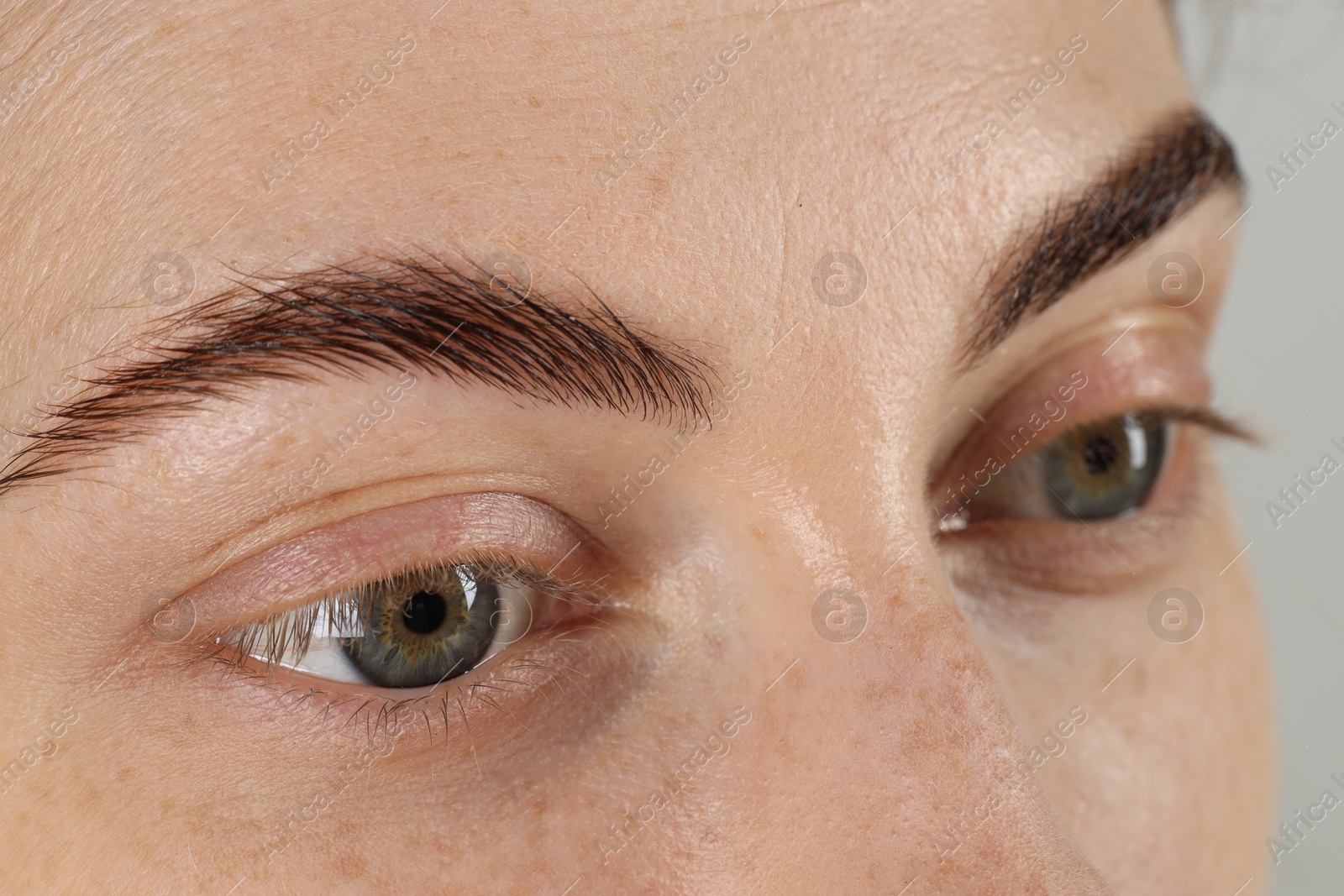 Photo of Closeup view of woman with beautiful eyes on light background