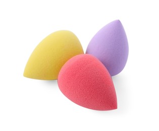 Photo of Three colorful makeup sponges isolated on white