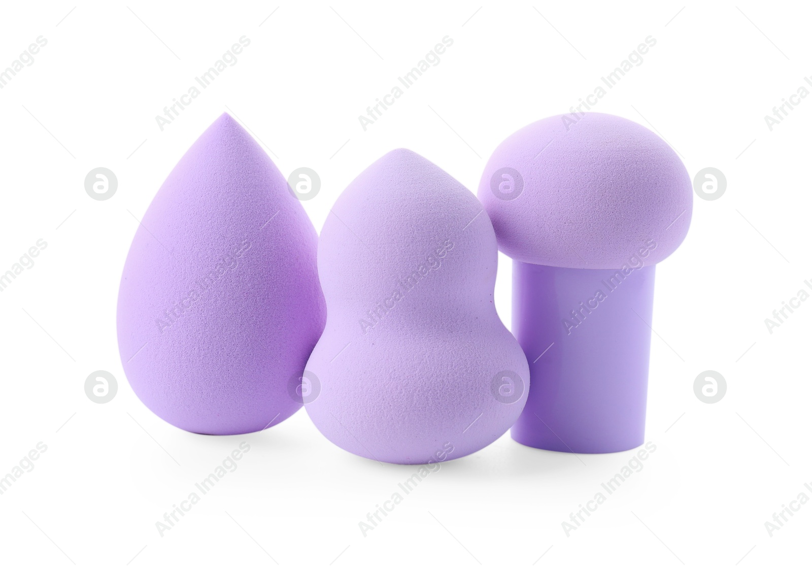 Photo of Three violet makeup sponges isolated on white