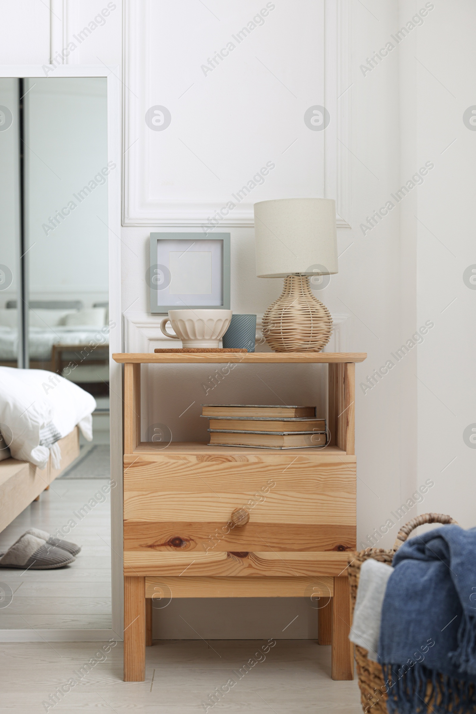 Photo of Stylish living room interior with bed, bedside table and lamp