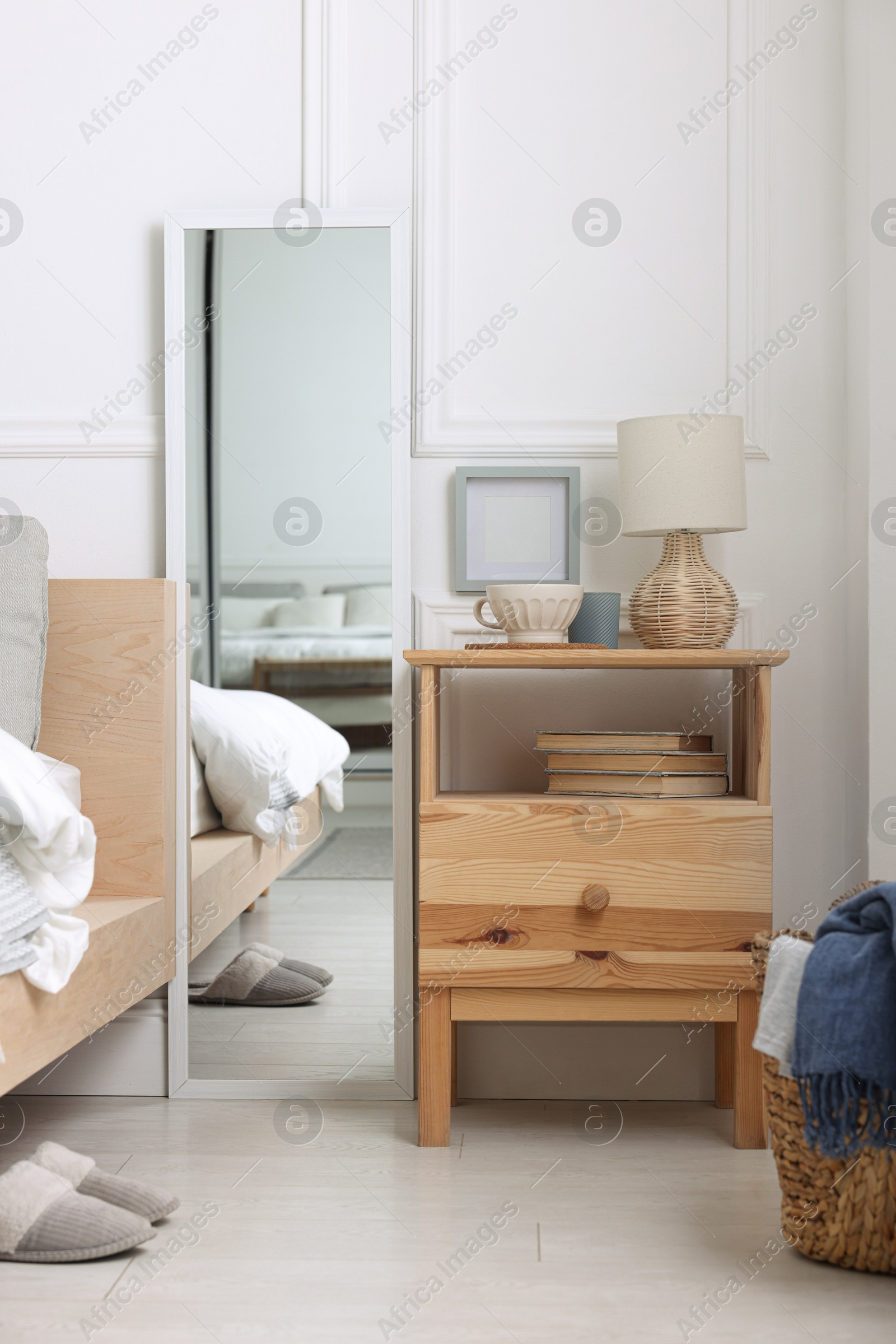 Photo of Stylish living room interior with bed, bedside table and lamp