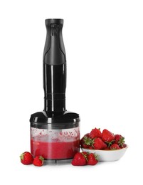 Photo of Hand blender with mixture of ingredients and strawberries isolated on white