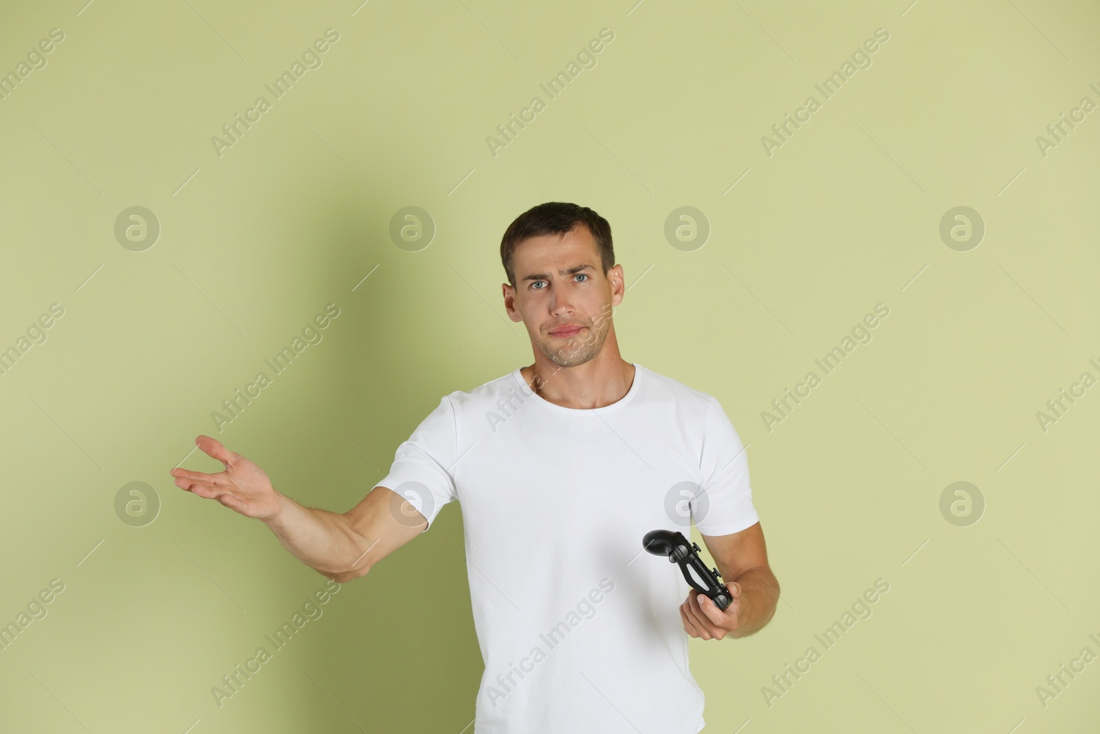 Photo of Man with controller on light green background