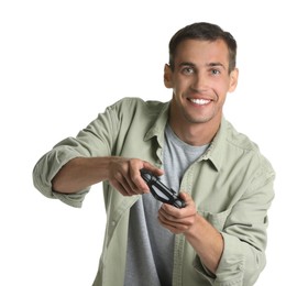 Happy man playing video games with controller on white background