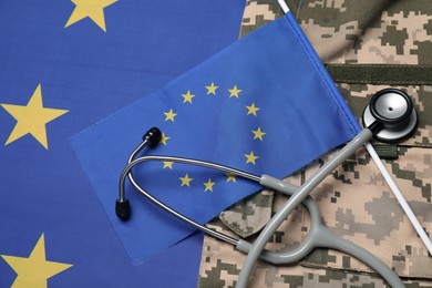 Photo of Stethoscope and military uniform on flag of European Union, top view