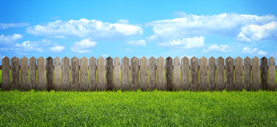 Wooden fence and green grass outdoors, banner design