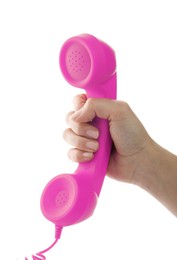 Woman holding pink telephone handset on white background, closeup