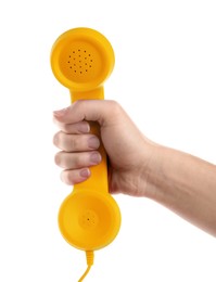 Woman holding yellow telephone handset on white background, closeup