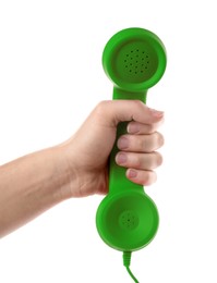 Woman holding green telephone handset on white background, closeup