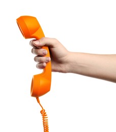 Woman holding orange telephone handset on white background, closeup