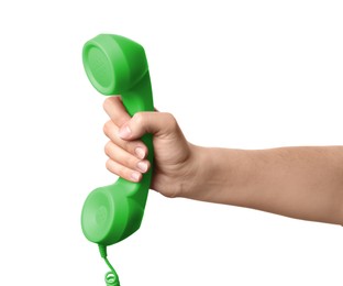 Woman holding green telephone handset on white background, closeup