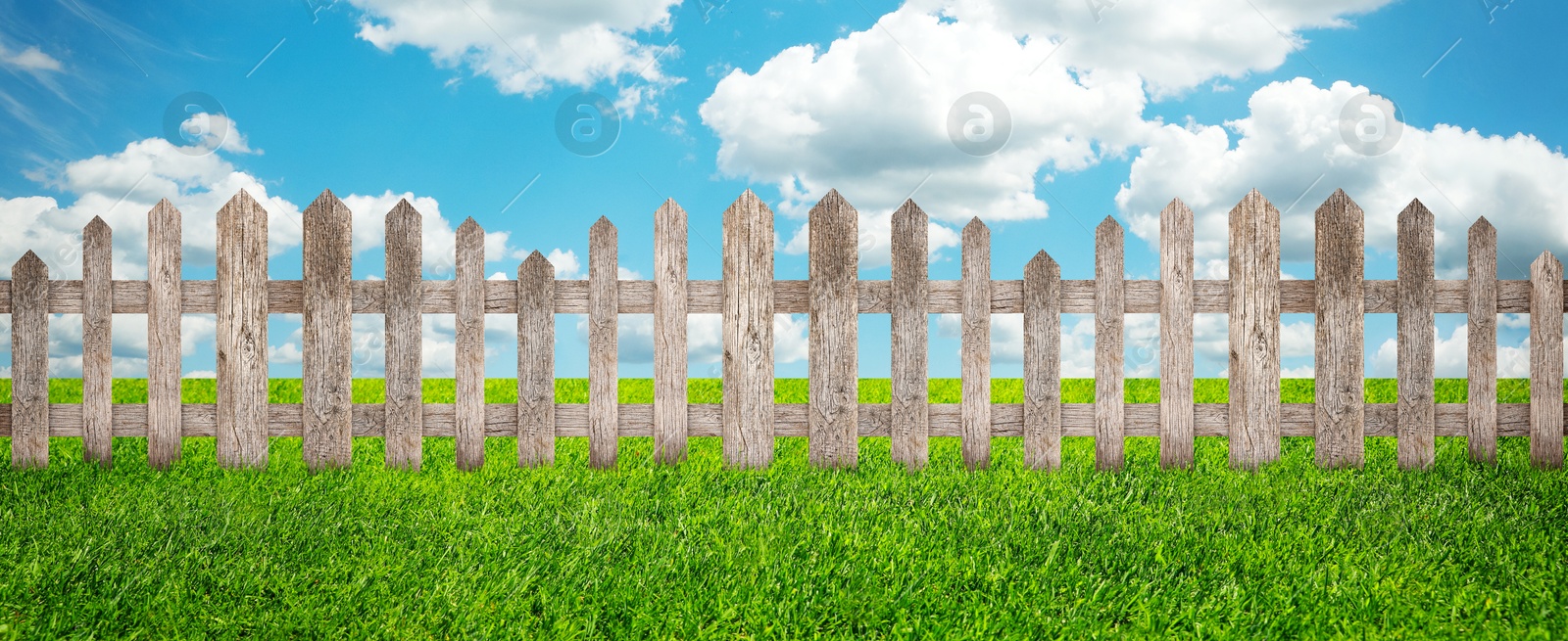 Image of Wooden fence and green grass outdoors, banner design