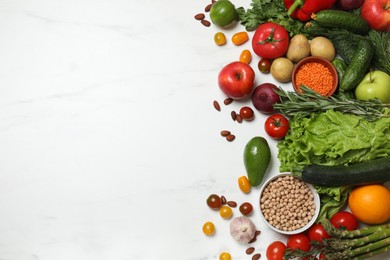 Source of protein for vegetarians. Different fresh vegetables, fruits and herbs on white marble table, space for text