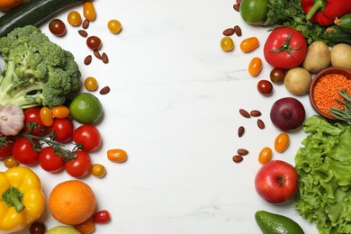 Source of protein for vegetarians. Different fresh vegetables, fruits and herbs on white marble table, space for text