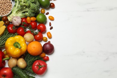 Source of protein for vegetarians. Different fresh vegetables, fruits and herbs on white marble table, space for text