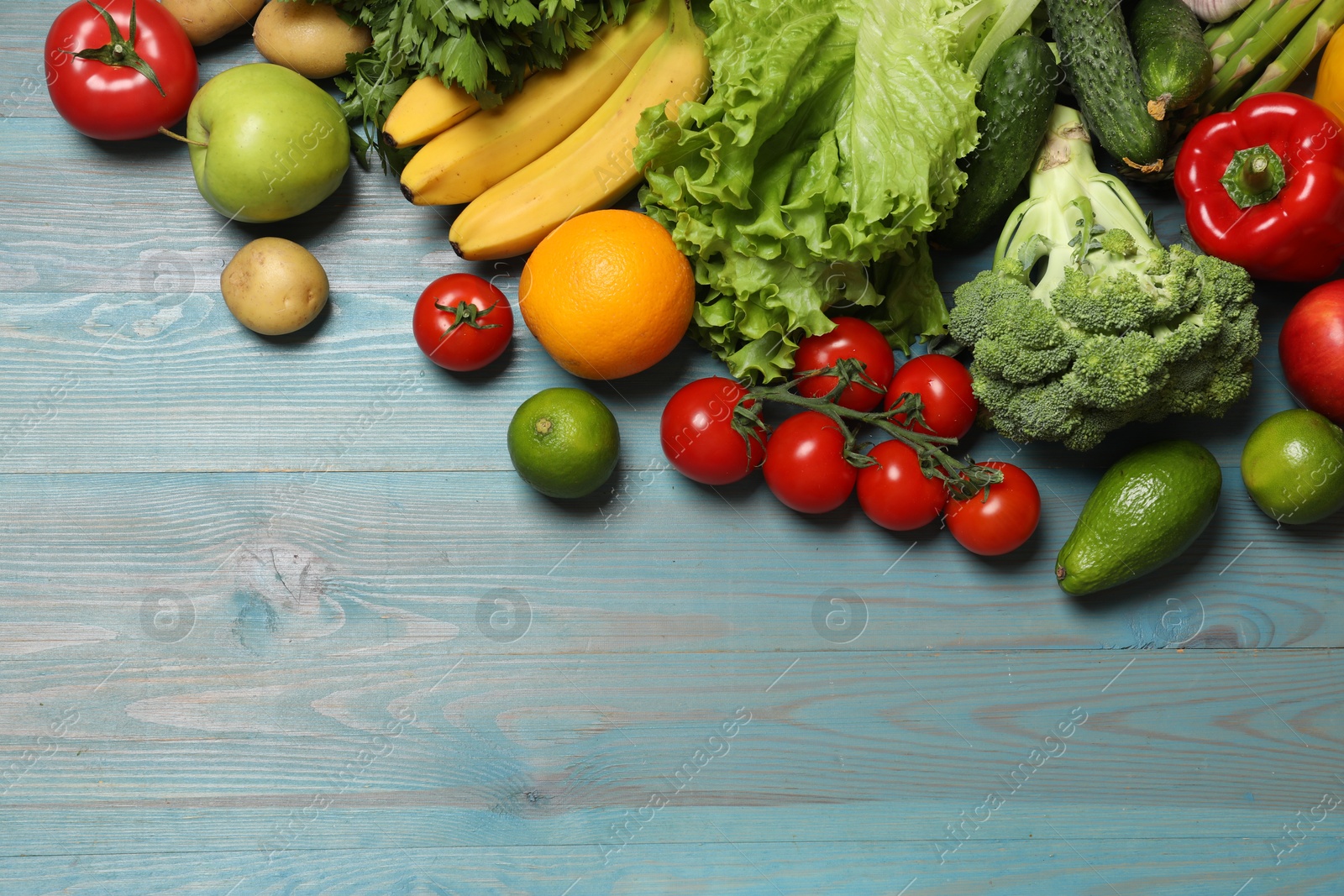 Photo of Source of protein for vegetarians. Different fresh vegetables, fruits and cereals on light blue wooden table, top view. Space for text