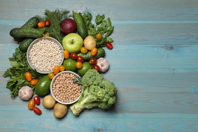 Photo of Source of protein for vegetarians. Different fresh vegetables, fruits and cereals on light blue wooden table, top view. Space for text