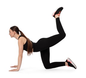 Young woman doing aerobic exercise on white background