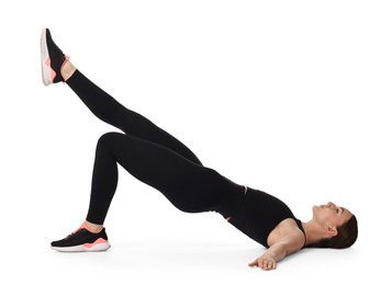 Young woman doing aerobic exercise on white background