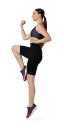 Young woman doing aerobic exercise on white background