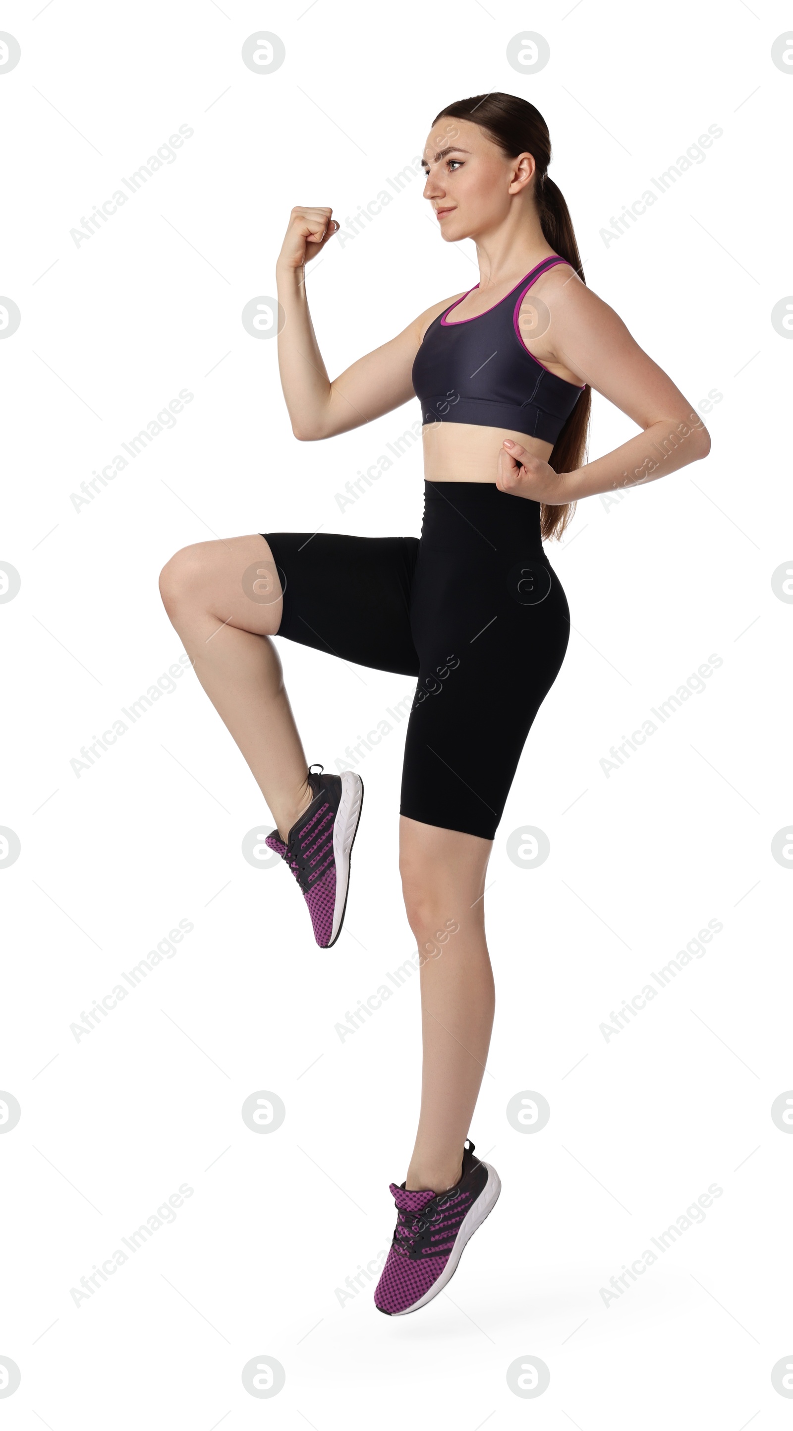 Photo of Young woman doing aerobic exercise on white background