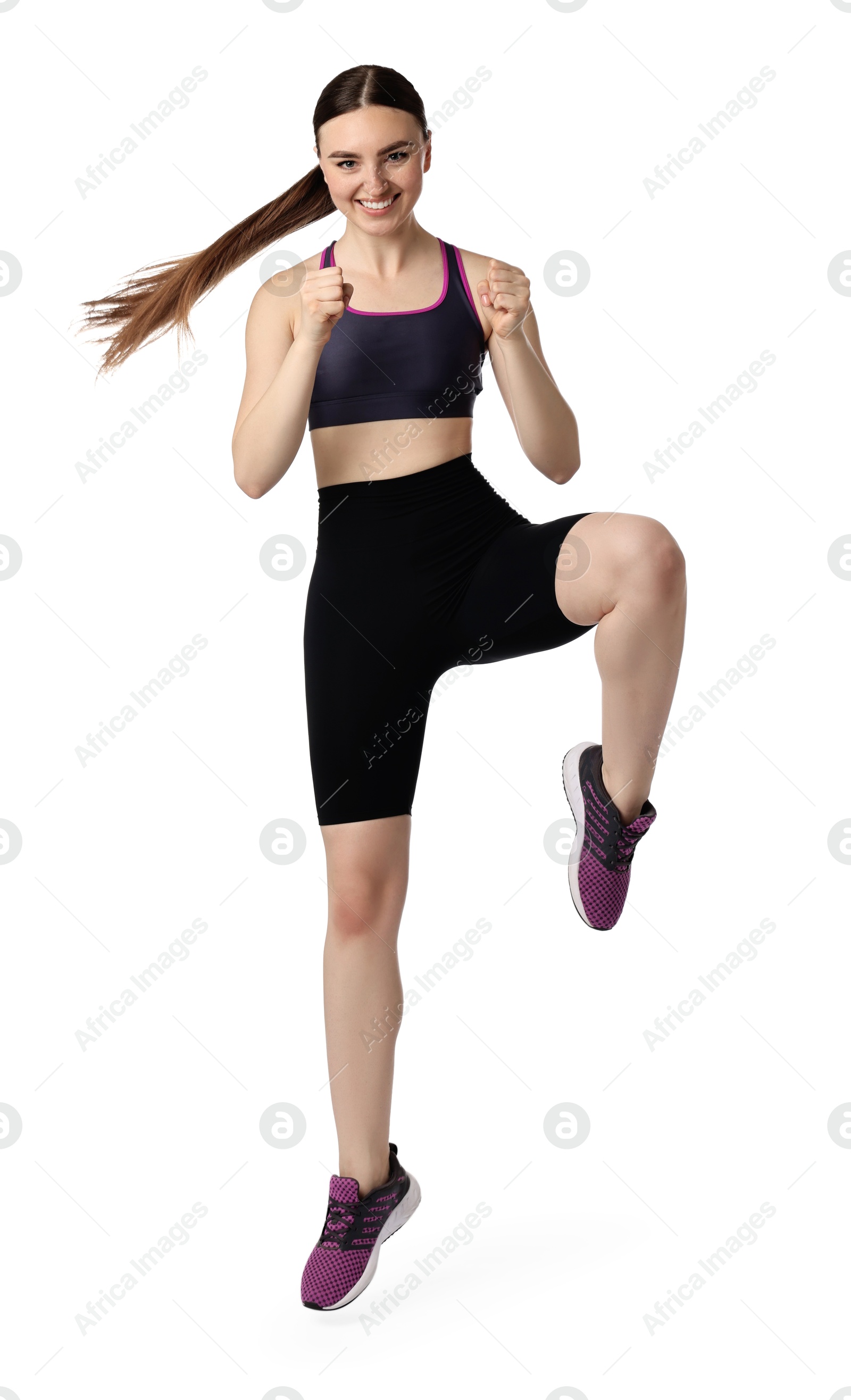 Photo of Young woman doing aerobic exercise on white background