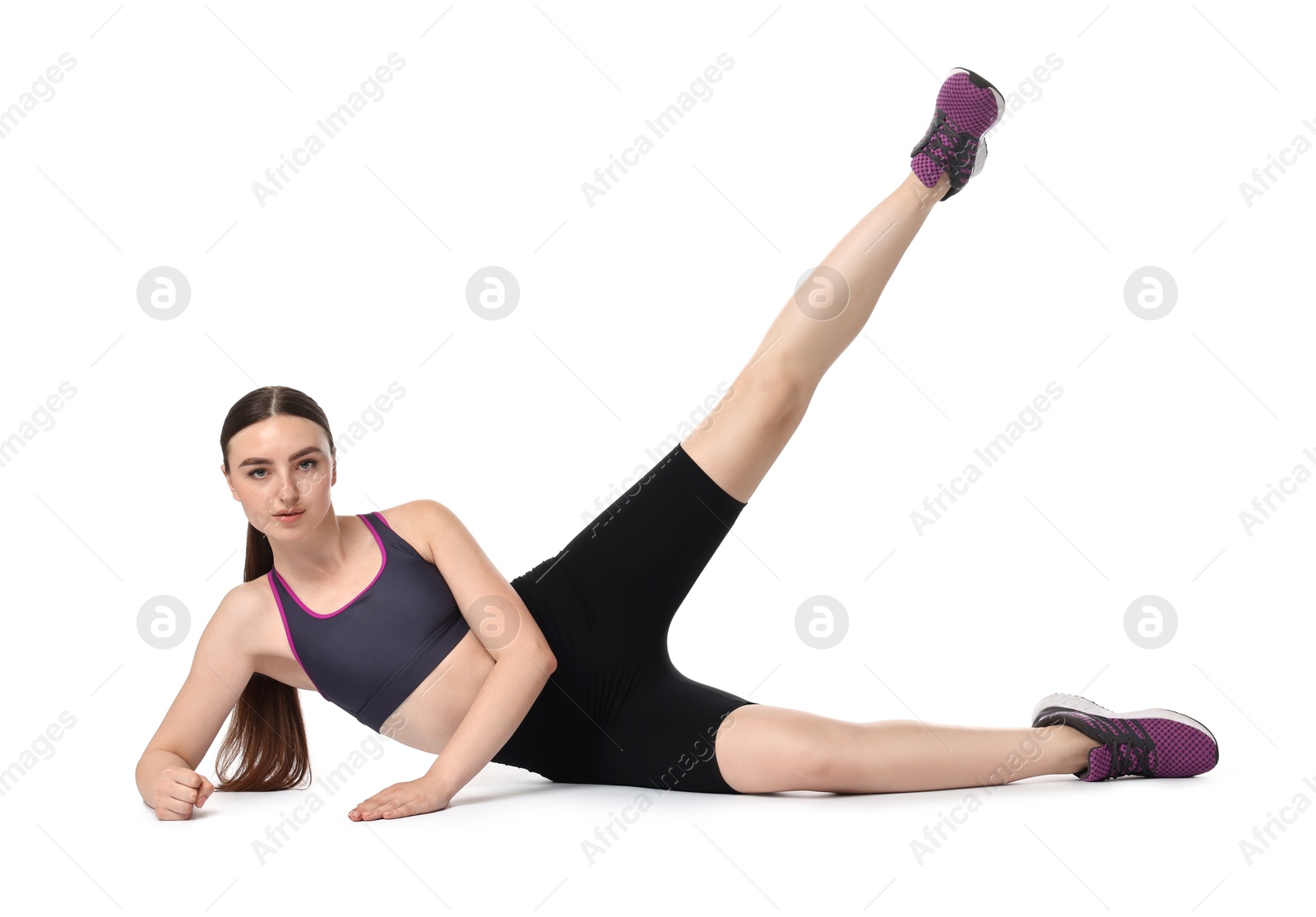 Photo of Young woman doing aerobic exercise on white background