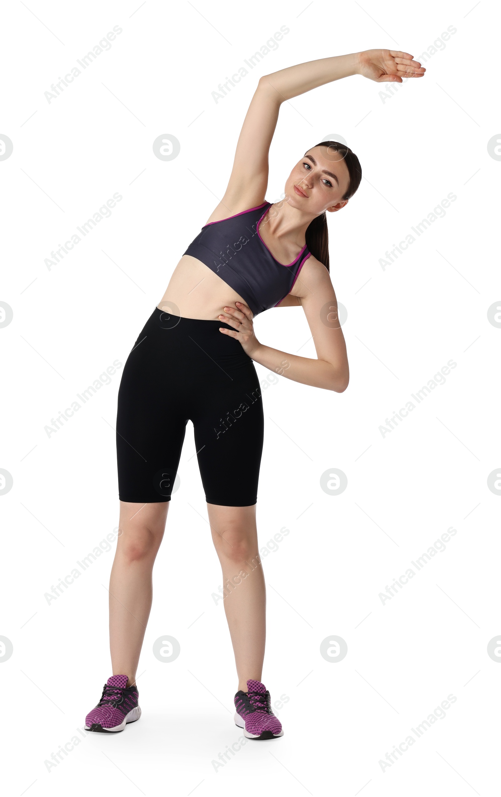 Photo of Aerobics. Young woman doing stretching exercise on white background