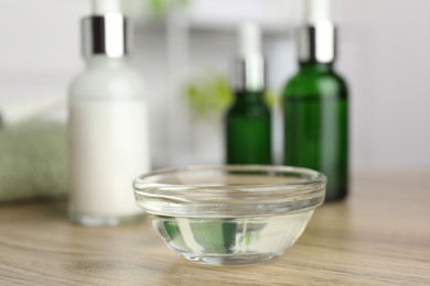 Peeling procedure. Chemical peel liquid in bowl on wooden table indoors, closeup